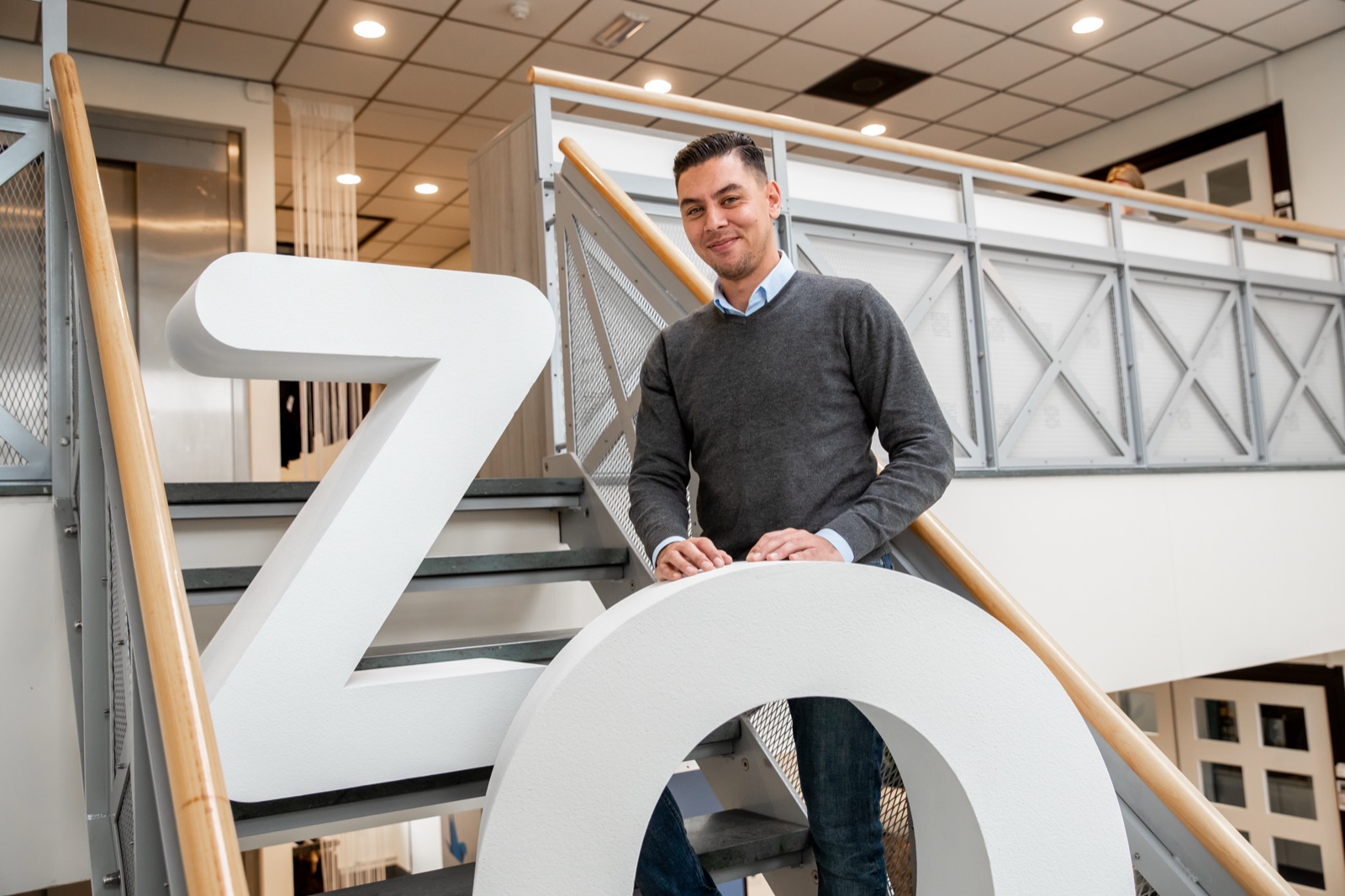 Employee with the ZO letters on the stairs